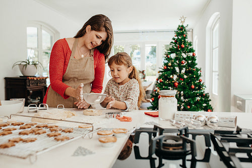 Mother and daughter making Christmas cookies.