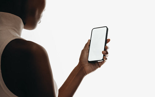 Person holding smartphone with blank screen for mobile mockups