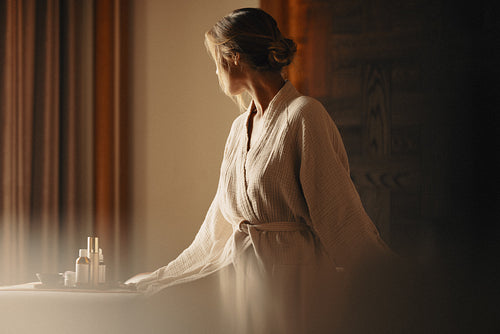 Luxury spa treatment for woman enjoying skincare routine in serene atmosphere
