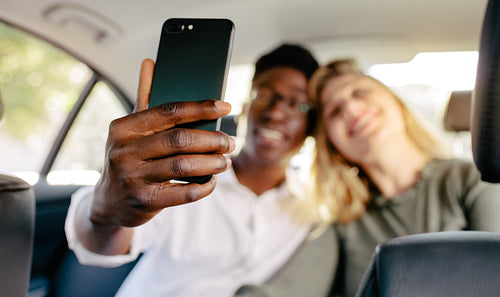 Couple in car taking selfie