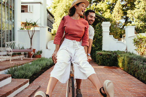 Couple having fun on a bike outdoors