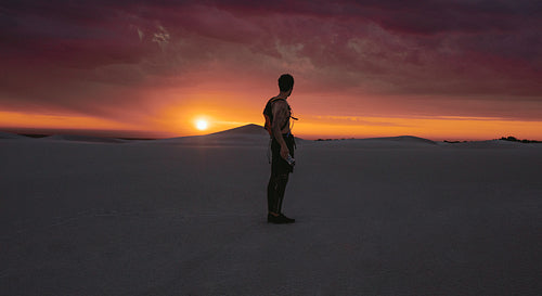Athlete looking at desert sunset