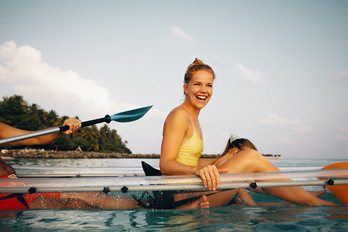 Family enjoying kayaking on a tropical sea under a sunny sky