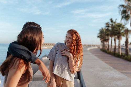 Friends sharing a hilarious moment on the promenade
