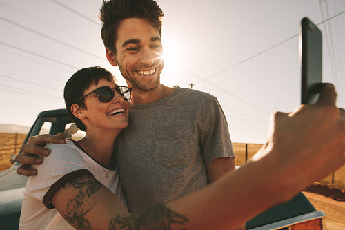 Couple on a road trip taking selfie