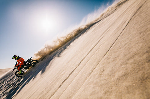 Motocross biker racing on his bike in desert