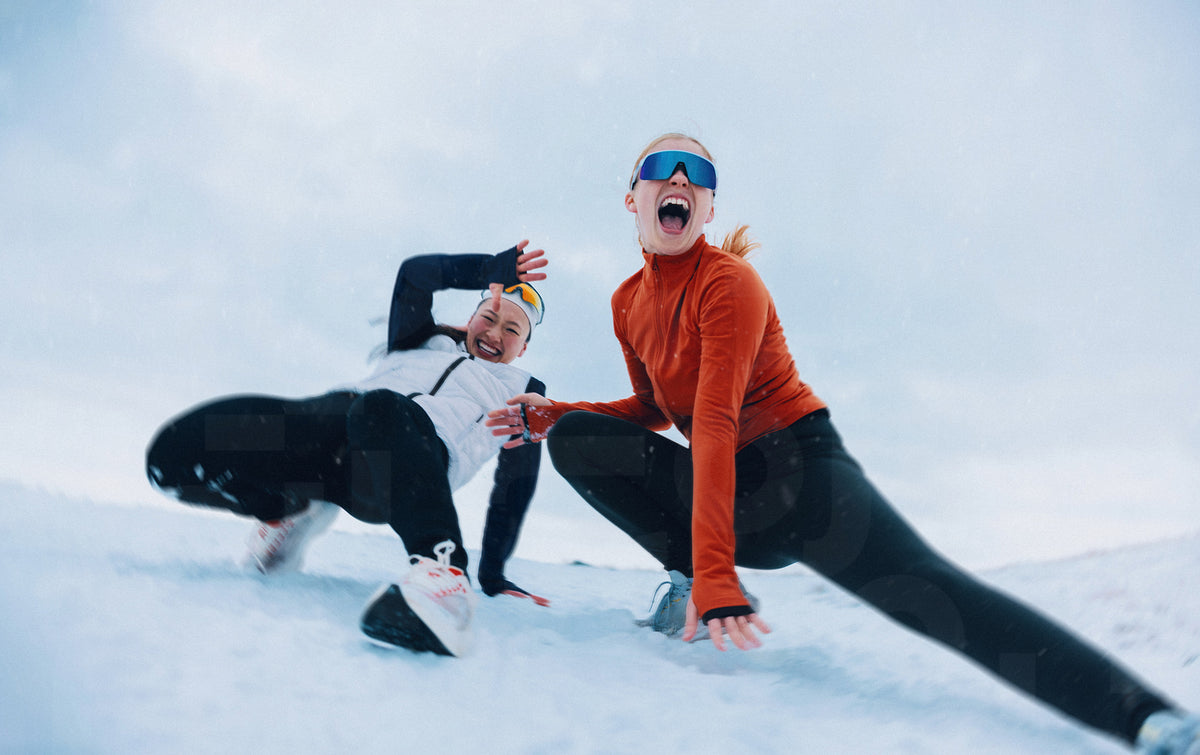 Women enjoying playful winter fun in the snow together – Jacob Lund ...