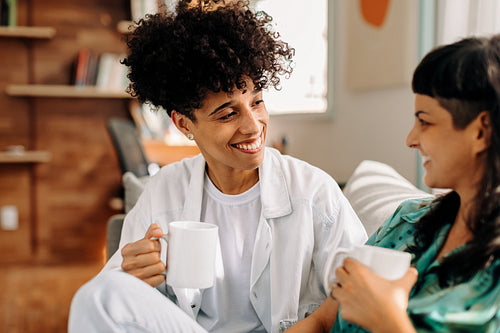 Female couple having coffee at home