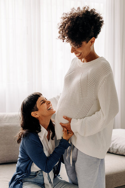 Excited pregnant couple laughing together