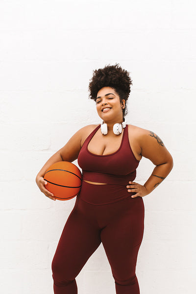 Plus size woman with basket ball