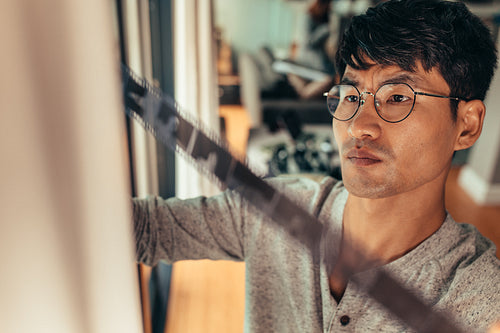 Man selects a frame on old filmstrip