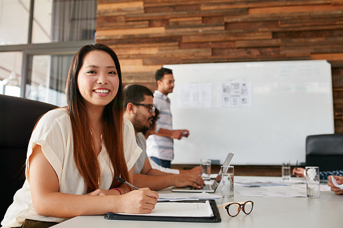 Asian woman smiling during business presentation