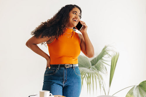 Young businesswoman speaking on the phone in a modern office