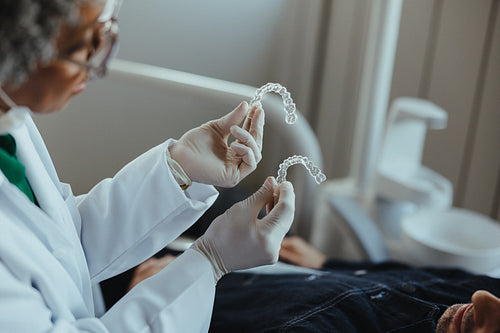 Dentist explains aligner treatment to a senior patient in modern clinic