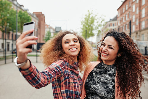 Two beautiful young women taking a picture together