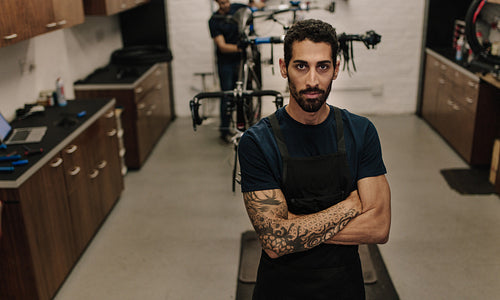 Workers repairing bicycles in workshop