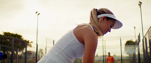 Athletic male and female padel players enjoy a competitive game on an outdoor court
