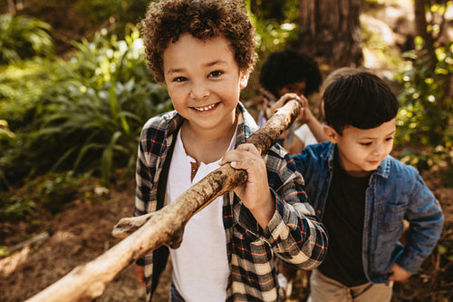 Children building camp in forest