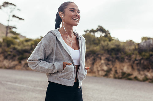Fitness woman walking on country road