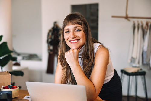 Happy thrift store owner smiling at the camera