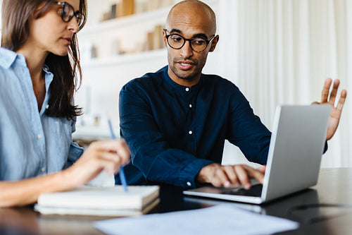 Business man discussing with his colleague in an office