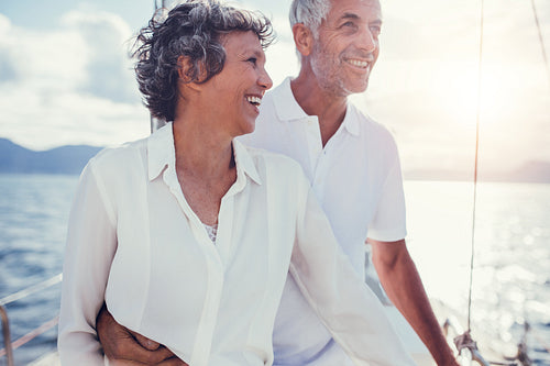 Happy mature couple standing on a boat