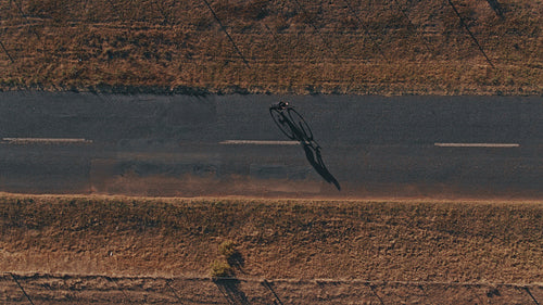 Sportsman cycling on the rural asphalt road