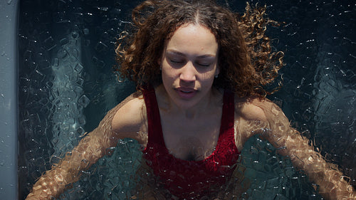 Woman uses breath in an ice bath for cold plunge recovery