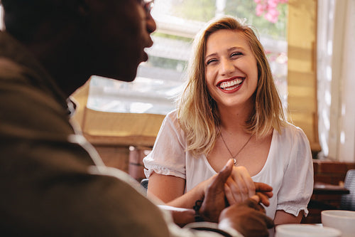 Interracial couple on date at cafe