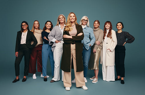 Smiling woman standing with a group of cheerful women