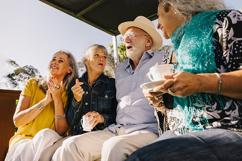 Old time friends laughing together over tea