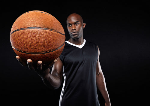 Basketball in hand of african sportsman