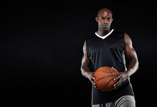 Black basketball player with ball