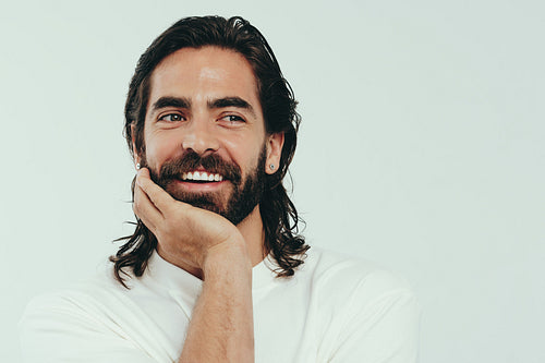 Masculine beauty: Handsome young man smiling in a studio