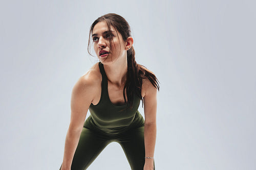 Woman leaning forward catching breath after workout