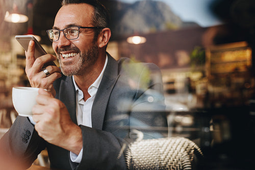 Businessman making a phone call from a coffee shop