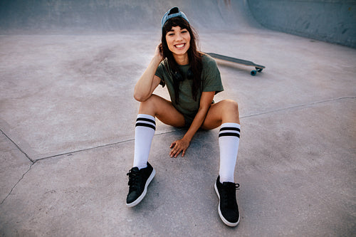 Skateboarder relaxing outdoors at skate park
