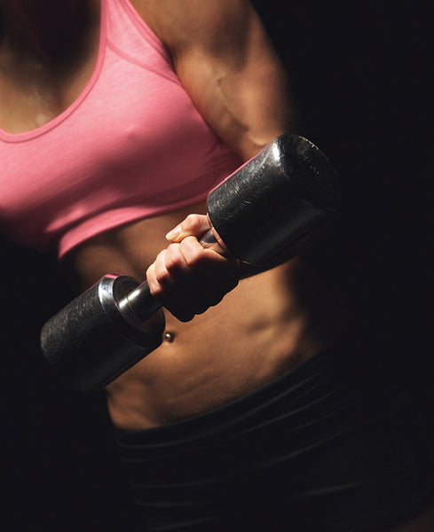 Active Athletic Woman with a Dumbbell