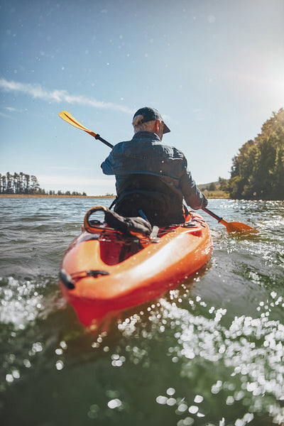 Mature man canoeing in a lake