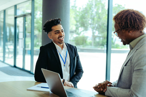 Casual client meeting in a modern office setting with natural light