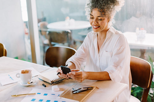 Smiling businesswoman using a smartphone