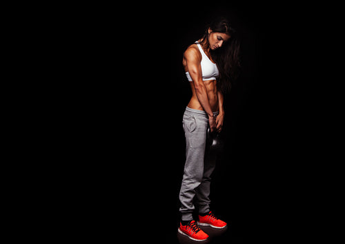 Sporty young woman doing crossfit workout