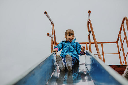Girl sliding at playground