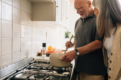 Senior couple cooking food together at home