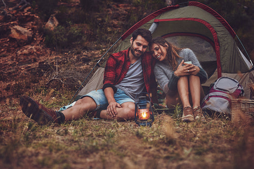 Romantic young couple camping in the forest