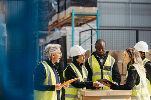 Diverse warehouse workers having a meeting