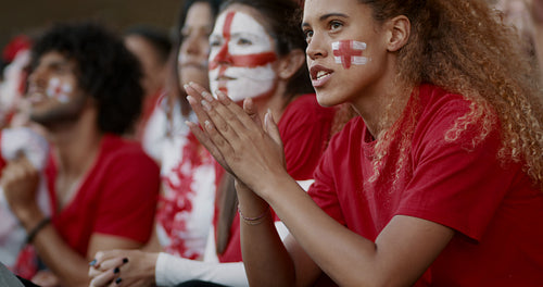 English soccer fans watching a game anxiously