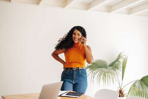 Female entrepreneur speaking on the phone in a boardoom