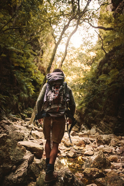 Man hiking through rough and rocky mountain trail
