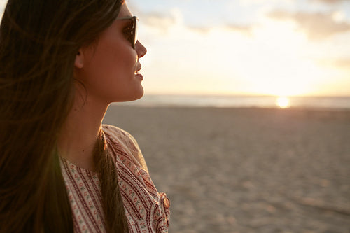 Attractive woman on the beach at sunset